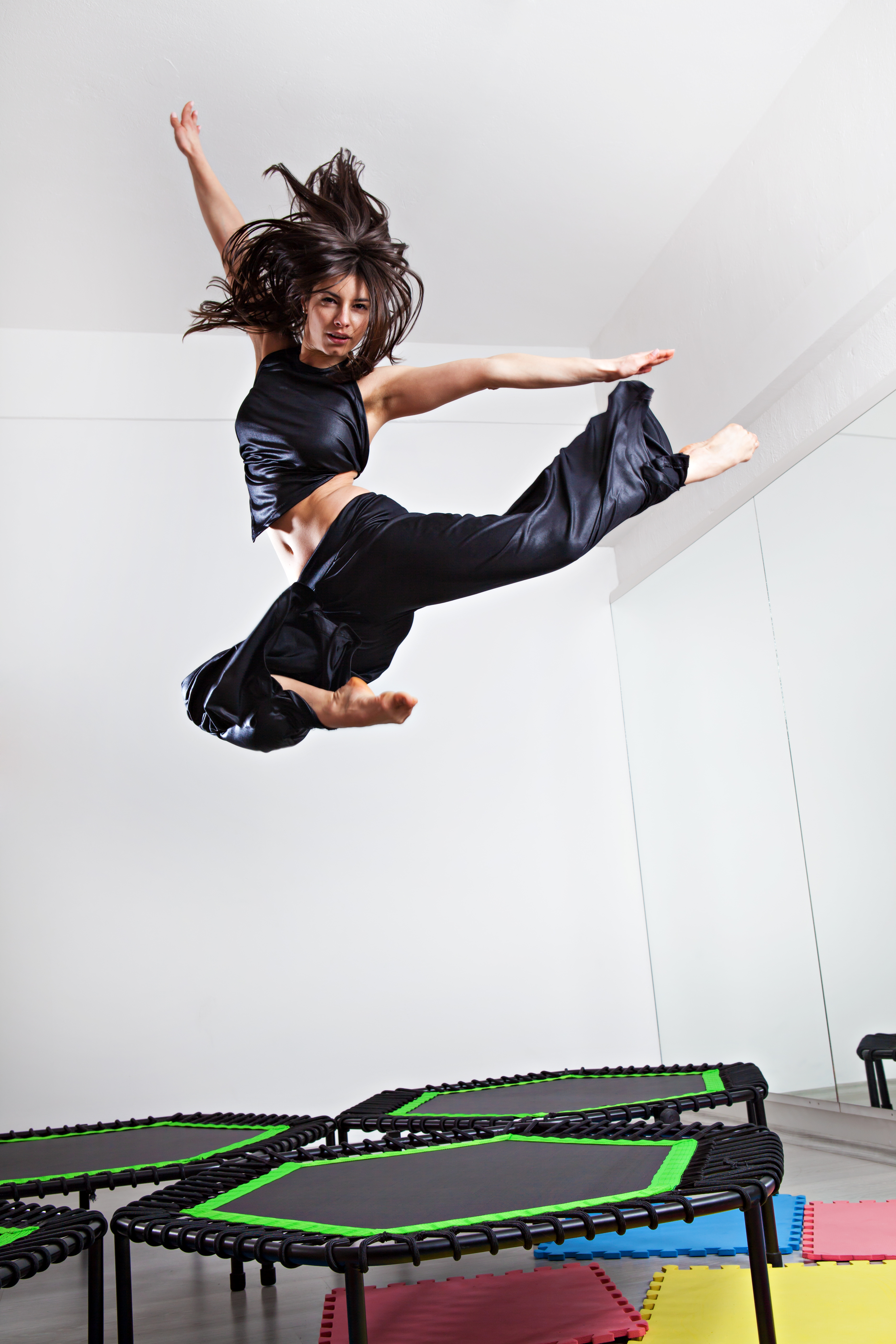 Jumping young woman on a trampoline.
